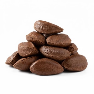May include: A small pile of whole Brazil nuts with hard, dark brown, wrinkled shells. Each nut has a distinct crescent or triangular shape with a textured, woody surface. The nuts are stacked together in a cluster against a plain white background.