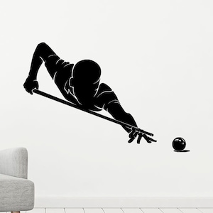May include: Black silhouette of a person playing pool, holding a cue stick and aiming at a white ball.