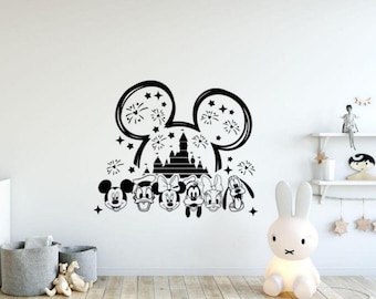 May include: Black wall decal featuring Mickey Mouse ears with a castle silhouette and fireworks. Below are the faces of Mickey, Minnie, Donald, Goofy, and Pluto. A fun, decorative accent for a child's room.
