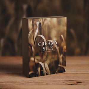 May include: A box with a brown background image of dried grass and the text "Creamy Silk Color Grading LUT" printed in white.