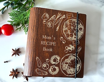 May include: A brown wooden recipe book with a gold engraved design of food and the text "Mom's RECIPE Book".