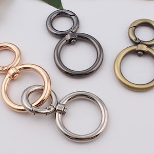 May include: Three double-ring keychains in different finishes: gold, silver and black.