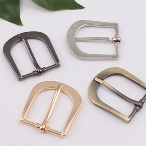 Puede incluir: Cuatro hebillas de cinturón de metal en diferentes acabados: plata, oro, negro y latón antiguo. Cada hebilla tiene un diseño clásico de anillo en D.