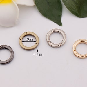 May include: Three metal key rings in different colors: gold, silver, and black. Each ring is 19 mm in diameter and 4.5 mm wide.