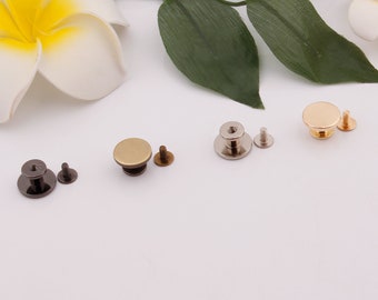 May include: Four sets of metal snaps, each with a round head and a screw. The snaps are in different finishes: black, brass, silver, and gold.