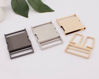 May include: Three metal slider buckles in different finishes: silver, black, and gold. The buckles are designed for use with webbing or straps.