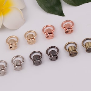 May include: Assortment of ten metal swivel snap hooks in various finishes, including gold, silver, rose gold, and black.