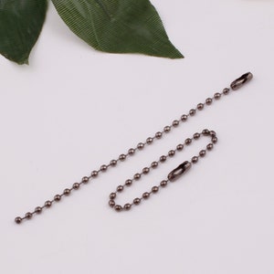 May include: A silver ball chain with two swivel clasps. The chain is approximately 18 inches long.