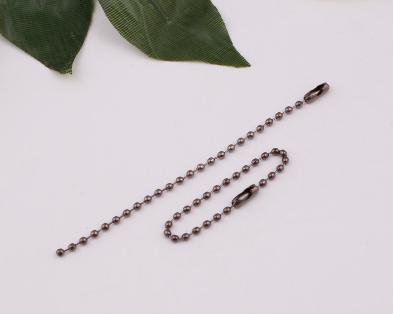 May include: A silver ball chain with two swivel clasps. The chain is approximately 18 inches long.