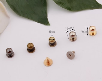 May include: Assortment of six metal dome-shaped studs in various sizes and finishes, including gold, silver, and black. The studs are 6mm, 7mm, and 8mm in diameter.