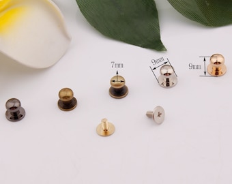 May include: Five different metal knobs with a round top and a flat base. The knobs are in various finishes, including gold, silver, and black. The knobs are 7mm and 9mm in diameter.