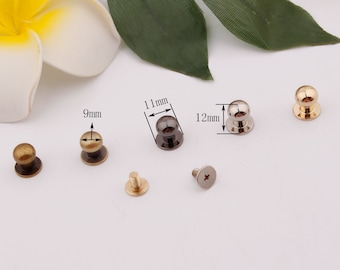 May include: Assortment of five metal dome-shaped knobs with screw. The knobs are in three sizes: 9mm, 11mm, and 12mm. The knobs are in gold, silver, and bronze.