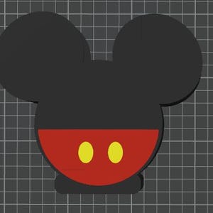 May include: A black and red Mickey Mouse head design with two yellow circles. The design features a black head with two large ears, a red lower face, and two yellow circles representing the eyes.