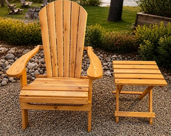 May include: A wooden Adirondack chair and matching side table set. The chair has a high back with vertical slats and curved armrests. The side table is square with a slatted top. Both are made of light-colored wood.
