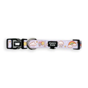 May include: Purple dog collar with a rainbow, cloud and star pattern. The collar has a black buckle with the text "Fuzzy Paw" on it.