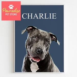 May include: A framed portrait of a gray dog with the name "CHARLIE" in white text on a navy blue background. The dog has a white patch on its chest and a pink tongue. The upper left corner has a logo that says "Pawradise PET STORE".