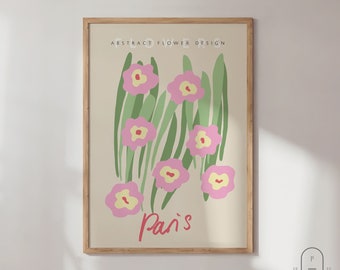 May include: A framed print with a beige background featuring an abstract floral design with pink flowers and green leaves. The text "ABSTRACT FLOWER DESIGN" is at the top of the print. The text "Paris" is at the bottom of the print in red.