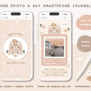 May include: A digital phone screen mockup with a pink and white background. The screen shows a photo of a sunset with a vintage van in the foreground. The text "Bear-ti-full" is on the screen. The text "One Photo A Day" is on the screen. The text "Monday Sunshine 16 Degree" is on the screen. The text "Road Trip to Calgary with Hubby" is on the screen. The text "Dinner @ Japanese Village" is on the screen. The text "12,500 Likes" is on the screen. The text "2023 Dated Hyperlinked" is on the screen. The text "Bonus Notes" is on the screen. The text "Monday Starts + Sunday Starts" is on the screen. The text "Works on Android and iOS" is on the screen. The text "Hyperlinked Pages" is on the screen.