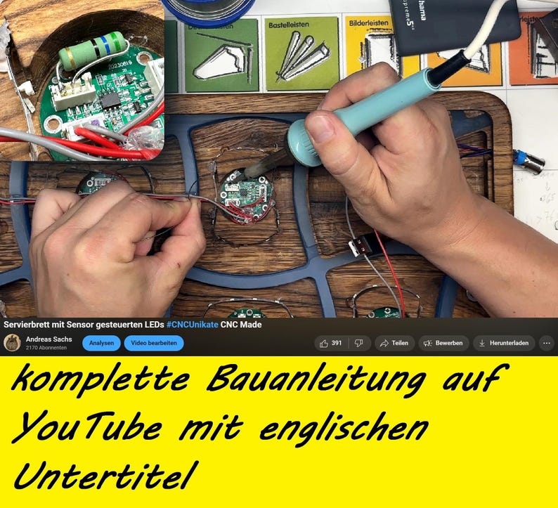 May include: A person soldering wires to a circuit board, part of a wooden serving board with LED lights. The image includes text in German, advertising a complete building guide on YouTube with English subtitles.