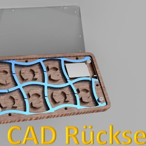 May include: A wooden box with a blue grid design and a clear lid. The box has a rectangular shape with curved cutouts. The text "CAD R&uuml;ckseite" is displayed in yellow at the bottom of the image.