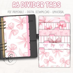 May include: A6 divider tabs with a pink bow design. The tabs are shown inside a black binder. The tabs are labeled "PDF PRINTABLE - DIGITAL DOWNLOAD - UNIVERSAL". The tabs have a watercolor bow pattern.