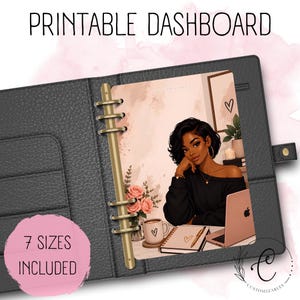 May include: A black leather-textured binder containing a printable dashboard insert. The insert features an illustration of a person with dark hair, a black off-shoulder top, a laptop, a mug with a heart, and pink roses. Text reads PRINTABLE DASHBOARD.
