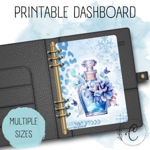 May include: Printable dashboard insert featuring a blue floral perfume bottle design with butterflies. The insert is displayed in a black binder. Text on the insert reads "PRINTABLE DASHBOARD". The text "MULTIPLE SIZES" is also visible.