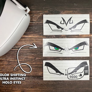 May include: Three black and white vinyl stickers with a graphic of a pair of eyes. The eyes are outlined in black and have a white eyebrow. The top sticker has a black pupil. The middle sticker has a green pupil with a blue ring around it. The bottom sticker has a black pupil and the text "9000" in white.