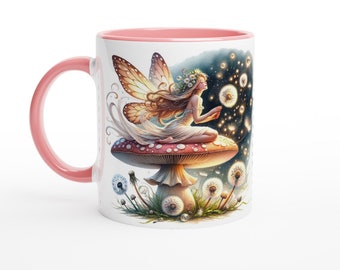 May include: A white ceramic mug with a pink rim features a whimsical illustration of a fairy sitting on a red and white mushroom. The fairy has golden wings and is surrounded by dandelion seeds.