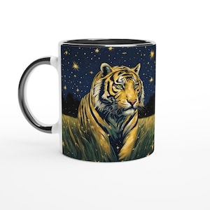 May include: A white ceramic mug with a black interior and handle, depicting a tiger in a field under a starry night sky. The tiger has yellow and black stripes and green eyes. The mug is suitable for hot beverages.
