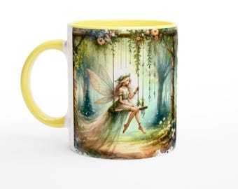 May include: A yellow and white ceramic mug with a fairy sitting on a swing in a forest scene. The fairy has long blonde hair and is wearing a white dress. The forest is filled with green trees and flowers.