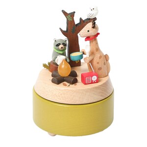 May include: Wooden music box with a giraffe, raccoon, and owl figurine. The giraffe is holding a bowl and the raccoon is holding a cup. The music box is playing a song about camping.