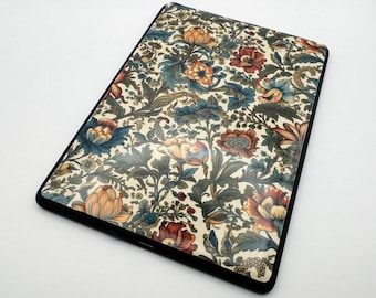 May include: A black case with a floral pattern in shades of orange, red, blue, and green. The case has a white background and a black border.