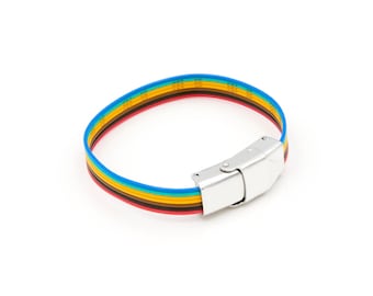 May include: A rainbow colored bracelet with a silver clasp. The bracelet is made of a flat, woven material.