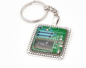 Green printed circuit board keychain with microprocessor, square frame metal alloy, protected with Epoxy resin - Bisuttronics.