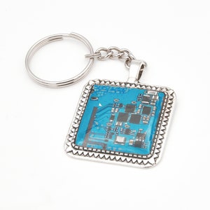 Blue printed circuit board keychain, square frame metal alloy, protected with Epoxy resin - Bisuttronics.