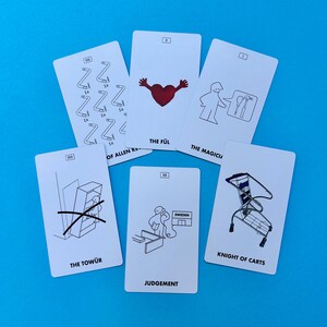 May include: Six white cards with black and red illustrations and text, including "THE F&Uuml;L", "THE MAGICIAN", "THE TOW&Uuml;R", "JUDGEMENT", and "KNIGHT OF CARTS". The cards are arranged on a blue background.