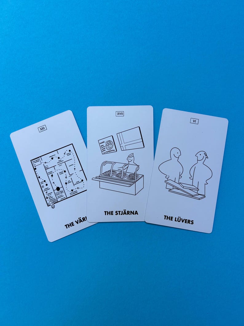 May include: Three white tarot cards with black line art illustrations and text against a blue background. The cards feature images of a map, a display case, and two figures. The text on the cards reads "THE V&Auml;RL," "THE STJ&Auml;RNA," and "THE L&Uuml;VERS."