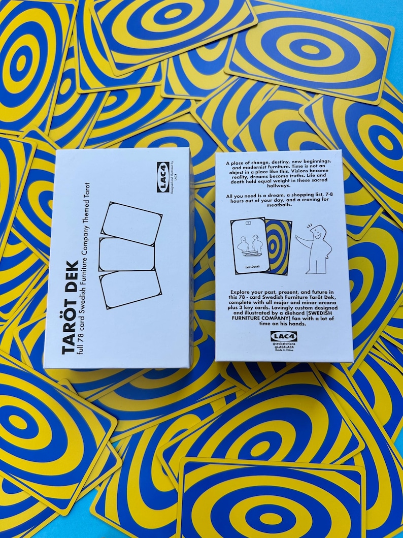 May include: A tarot deck with a white box featuring the text "TAR&Ouml;T DEK" and "full 78 card Swedish Furniture Company Themed Tarot." The deck includes cards with blue and yellow concentric circle designs. The box has text describing the deck.