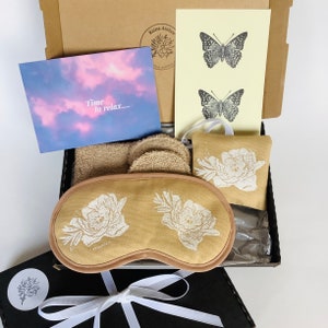 Spa Relaxation Gift Set with white peonies lavender infused eye mask, lavender sachet, post card and reusable makeup removal pads and soap bag