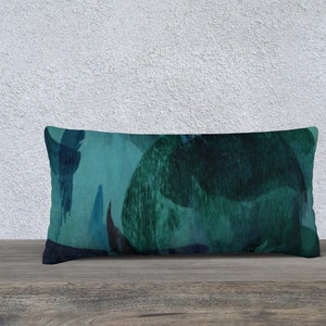 May include: A teal and dark blue rectangular throw pillow with an abstract pattern.