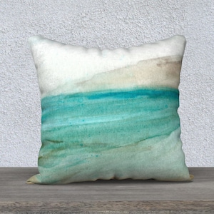 May include: A decorative throw pillow with an abstract watercolor design featuring shades of teal, blue, and brown. The pillow is made of soft fabric and has a subtle sheen.