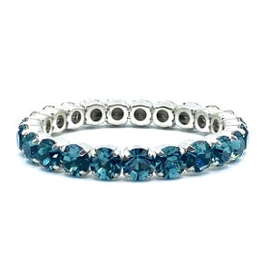 May include: A teal blue crystal stretch bracelet with a silver metal band.