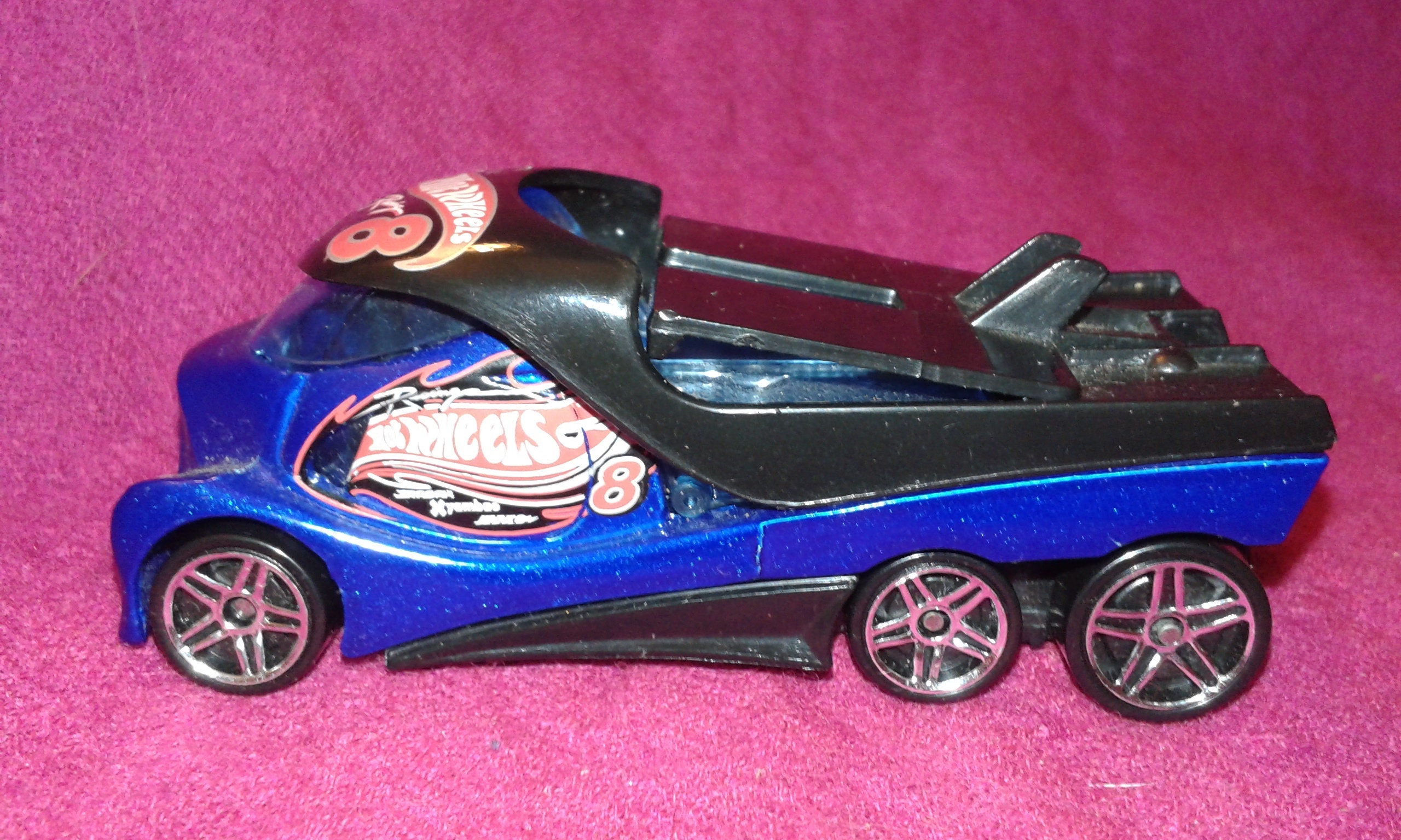 Hot Wheels CABBIN FEVER towing truck, painted black and dark blue, with a message above its front window screen
