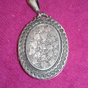 A Victorian pure silver hand etched engraved locket with ivy leaves and Edwardian photo of a Royal Navy soldier
