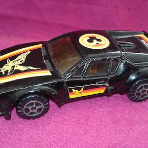 Eagle sports toy car, painted in black with red and  yellow details