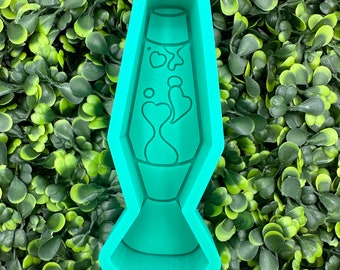 May include: A teal green silicone mold shaped like a lava lamp. The mold has a detailed design of a lava lamp with a bulb at the top and a base at the bottom. The lava inside the lamp is depicted with a swirling pattern.