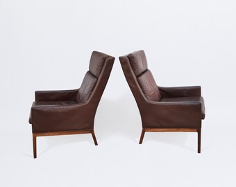 Pair of high back easy chairs by Kai Lyngfeldt Larsen