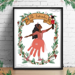 May include: A printable art print featuring a young Black ballerina in a pink tutu holding a Nutcracker doll. The ballerina is surrounded by a green wreath with red berries and gold bells. The text "The Nutcracker" is written in a gold banner above the ballerina.