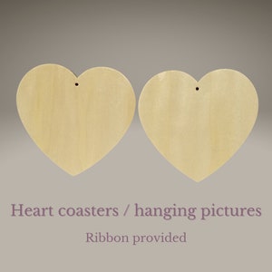 May include: Two unfinished wooden heart-shaped coasters or hanging pictures. Each heart has a hole for hanging and comes with a ribbon.